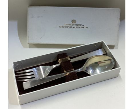 GEORG JENSEN: A silver spoon and fork with block pattern in original box. Approx. 99 grams. Est. £80 - £120.