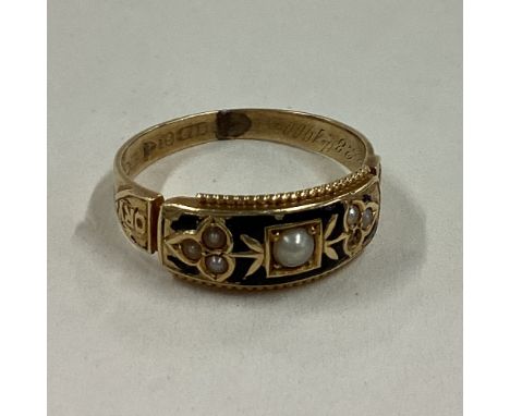 An enamel and pearl mourning ring in 15 carat gold mount. Approx. 3 grams. Est. £50 - £80.