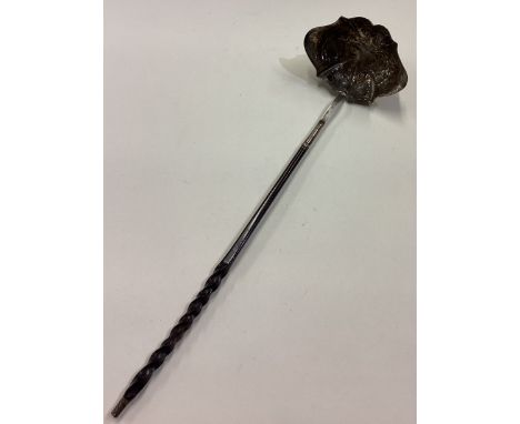 A large Georgian silver and whalebone toddy ladle with chased decoration. Approx. 46 grams. Est. £40 - £60.