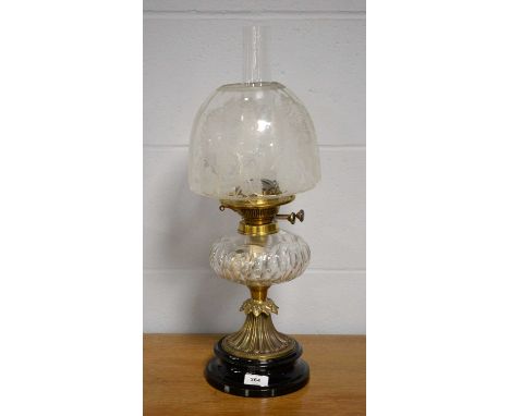 A 19th Century brass oil lamp, with cut glass reservoir and floral decorated glass shade, raised on a circular black base, 54