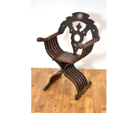 A carved walnut and mother-of-pearl inlaid Savonarola chair, early 20th Century, the profusely carved frame with a pierced sp