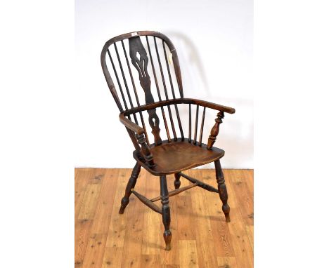 A 19th Century ash, elm and beech comb-back Windsor chair, the hooped backrest with pierced splat, solid seat, raised on turn