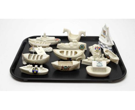 A collection of crested ceramic military interest and other model boats, including: a model of a paddle steamer, with Tynemou