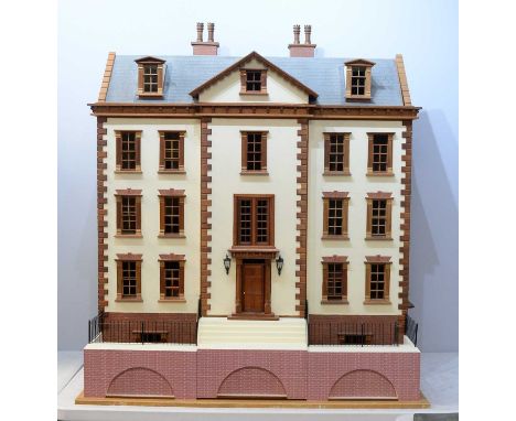 An impressive vintage five storey dolls house, in the form of a town house, with a faux brick and cream painted facade and wo