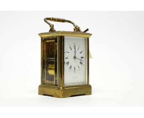 A 19th Century brass carriage clock, retailed by C. E. Sibley, Portsmouth, with white enamel roman dial, platform lever escap