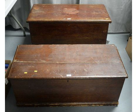 Two vintage stained wood blanket chests, each of typical form, with twin handles, the largest 95cms wide; containing an assor