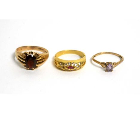 A ruby and white stone ring, on 18ct gold shank; a garnet ring, 9ct gold shank; and an amethyst ring, the gold shank stamped 