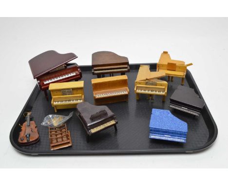 A collection of vintage dolls house musical instruments, comprising: a Kleeware plastic grand piano; two various Californian 