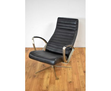 A vintage leather and brushed metal reclining swivel easy chair by Bo Concept, with cushioned elbow rests, raised on a five-p