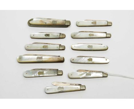 A collection of Victorian and later silver-bladed fruit knives, each mother of pearl gripscale handle with shield shaped cart