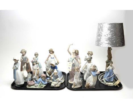 A collection of Lladro and Nao figures, including: a Nao decorative ceramic figural ‘Winged Friend’ table lamp, with associat