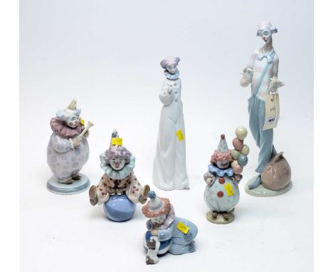 A collection of Lladro decorative ceramic clown figures, including: a clown sitting on a ball; a clown holding balloons; a cl