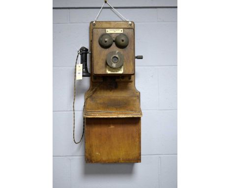 A vintage telephone stand, the wall mounting oak case 70cms high.