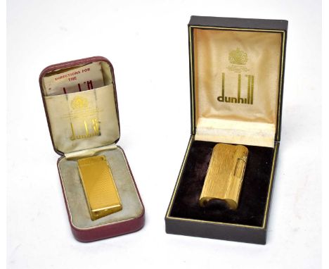 A Dunhill ‘S’ gilt metal cigarette lighter, model D80041, in box; together with a Dunhill ‘Rollagas’ gilt metal cigarette lig