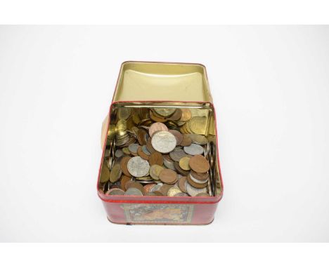 A collection of British and international coinage, predominately 20th century, contained in a vintage biscuit tin.