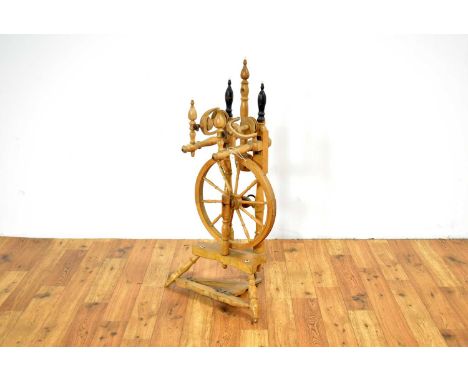 A vintage elm spinning wheel, raised on a three-point base, 90cm high, wheel diameter, 36cm.