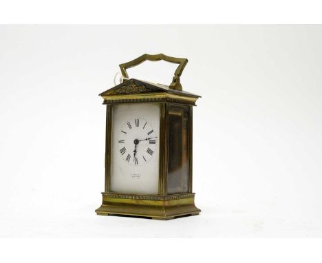 A 19th Century French brass carriage clock, retailed by J. Hall &amp; Co., Manchester, with white enamel Roman dial, platform