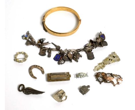 A gilt metal bangle; a selection of silver and other charms, and other jewellery.