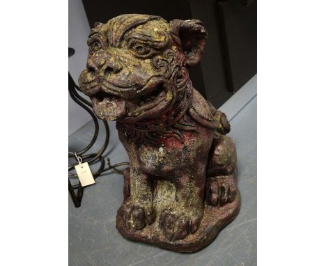 A Chinese carved stone Buddhist lion garden ornament, modelled seated, 51cms high.