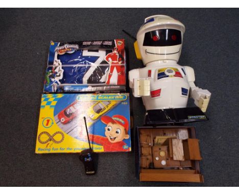 A good selection of children's toys to include a blue Power Ranger costume, My First Scalextric, a box of wooden doll's house