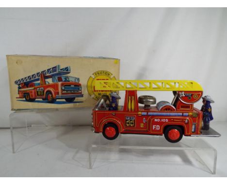 Usagiya - A Japanese friction powered, tinplate model fire engine by Usagiya, in original box, red body, yellow ladder and fi