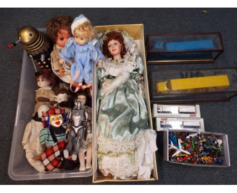 A good collection of toys comprising seven porcelain dolls of various sizes from 32 cm (h) to a Knightsbridge Collection doll