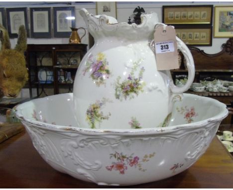 An Early 20th Century Pottery Jug and Basin; with decoration of flowers.
