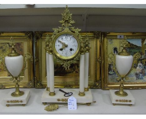 A Gilt Brass and White Marble Garniture De Cheminee comprising a portico clock, the white enamel dial with Arabic numerals, b