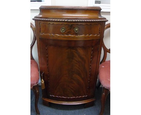 An Early 20th Century Chippendale Style Mahogany Pedestal Cupboard; with a carved pagoda top with a gadrooned edge, one drawe