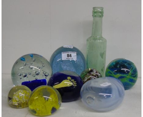 Seven Paperweights to include a Mdina glass example, a Vaseline glass bottle and a vintage green glass Worcester bottle (9).