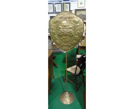 An Unusual Brass Armorial Pole Screen with an embossed design.