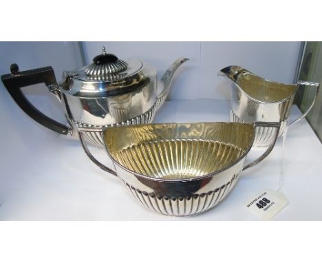 A Silver Half Reeded Three Piece Tea Service; the teapot Birmingham 1907, the sugar basin and jug , London: William Sutton & 