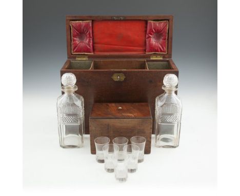 A LATE GEORGIAN UPRIGHT MAHOGANY CAMPAIGN DECANTER BOX with brass mounts and two fitted inset brass ring handles, the interio