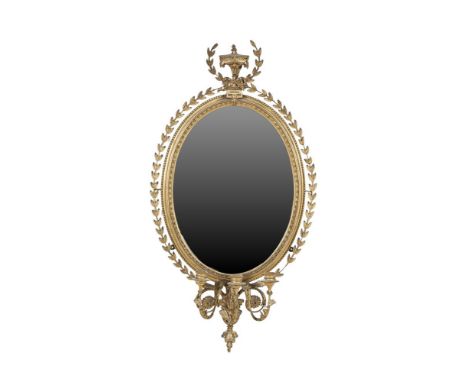 A 19TH CENTURY OVAL GILT GESSO WALL MIRROR, in the Neo-Classical taste, with three-light sconce, the oval glass plate enclose