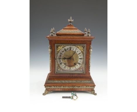 AN EDWARDIAN OAK CASED BRACKET CLOCK, with applied cast brass mounts