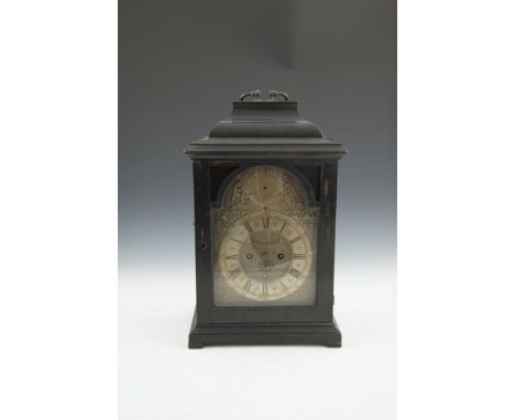 A GEORGE II EBON CASED BRACKET CLOCK, by R. Henderson, the domed top with brass carrying handle above a single, arched glazed