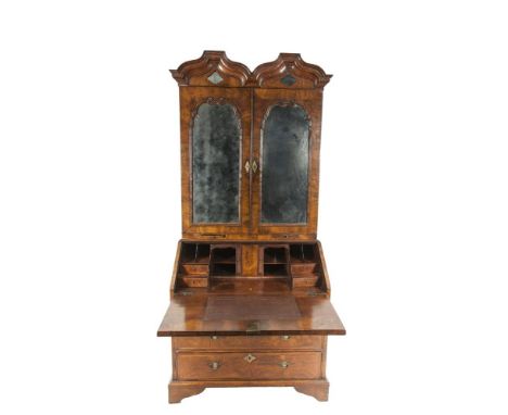 AN 18TH CENTURY QUEEN ANNE WALNUT VENEERED BUREAU CABINET, with a flat double domed cornice above twin mirror panel doors enc