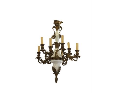 A FRENCH BRASS AND MILK GLASS EIGHT LIGHT CHANDELIER, the baluster and bell shaped column supporting foliate scroll formed br