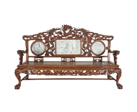 A CHINESE CARVED FRUITWOOD SETTEE, the back decorated with dragons and flowerheads and with inset marble panels above a solid