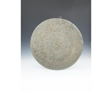 A LARGE BRASS AND SILVER INLAID CAIRO-WARE CHARGER, 74cm diameter; together with a Persian brass wall panel centered by a hun
