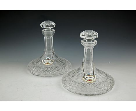 A NEAR PAIR OF CUT CRYSTAL SHIP'S DECANTERS AND STOPPERS, each also bearing a porcelain Staffordshire decanter label, one mar