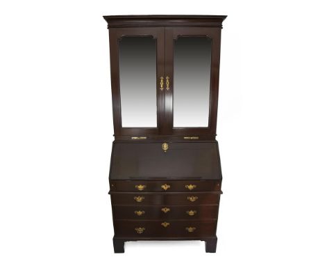 AN IRISH GEORGE II MAHOGANY BUREAU BOOKCASE, the moulded cornice above twin panel doors fitted with original bevelled mirror 