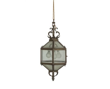 A BRASS HEXAGONAL HALL LANTERN, 19TH CENTURY, with bevelled glass plates, suspended from a corona. 68cmProvenance: St. Anne's