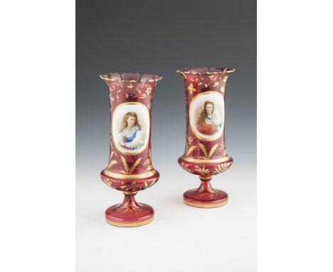 A PAIR OF VICTORIAN BOHEMIAN RUBY OVERLAID GLASS VASES, each with shaped serrated rim, the body decorated with enamel painted