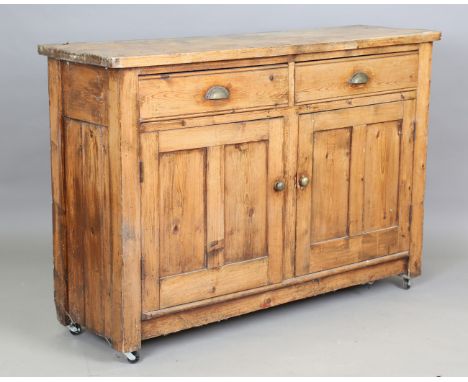 A late Victorian pine kitchen cabinet, fitted with brass handles, height 98cm, width 145cm, depth 44cm.Buyer’s Premium 29.4% 