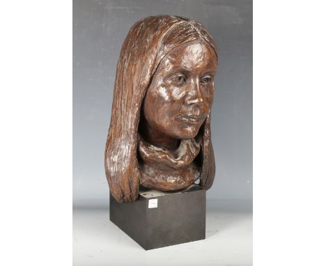 A late 20th century bronzed composite bust of a young girl, raised on a metal-clad wooden plinth, height 43cm.Buyer’s Premium