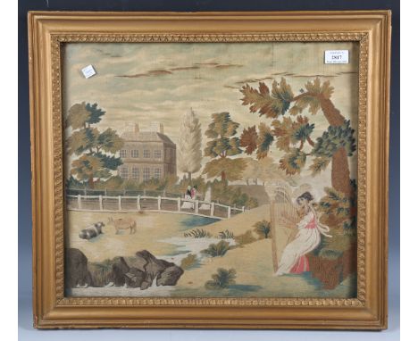 A Regency silkwork and chenille panel, worked in coloured threads with a lady playing a harp, seated within a garden with man