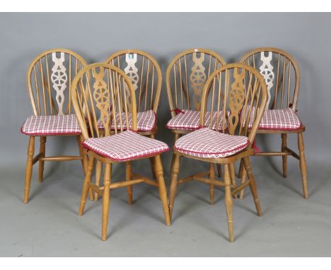 A set of six modern beech stick and wheel back kitchen chairs, height 90cm, width 38cm.Buyer’s Premium 29.4% (including VAT @