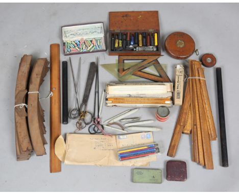 A group of mostly early 20th century surveyor's drawing instruments, including wooden curves, boxwood rules, a measuring stic