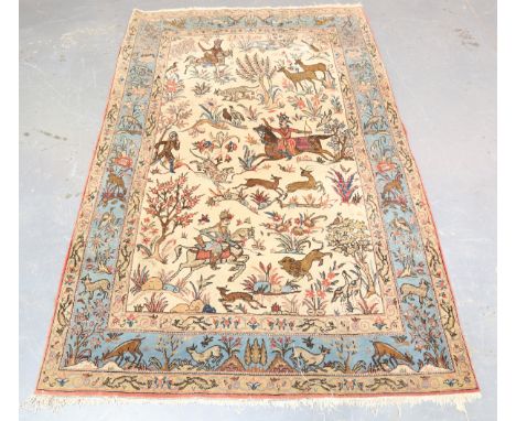 An Esfahan pictorial rug, Central Persia, mid-20th century, the ivory field with an overall hunting scene with figures on hor